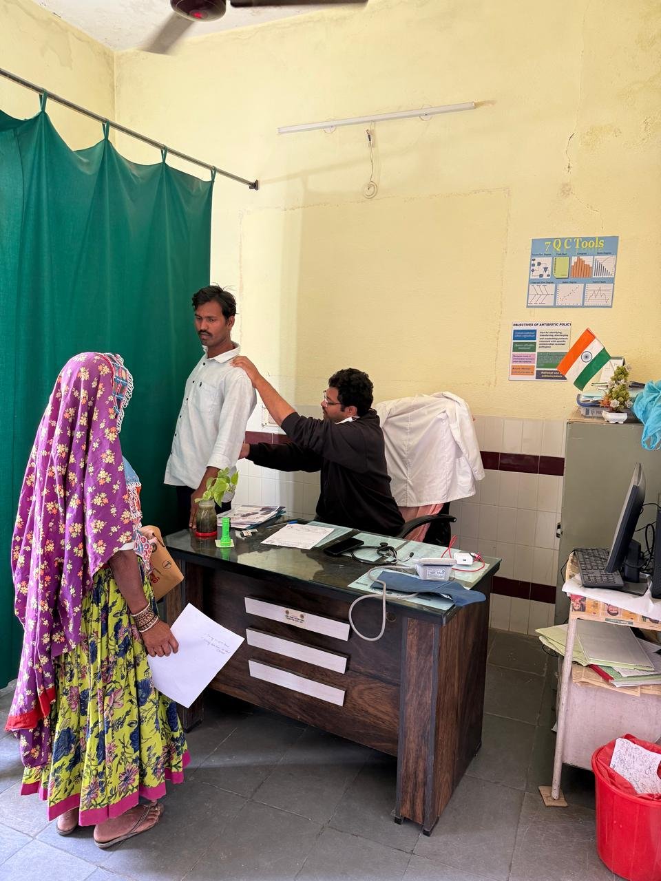 Doctor consulting patient and relative during daily ward rounds
